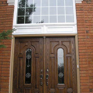 8 Panel Double Doors, Wood Grain with Transom Installed by Four Seasons Windows & Doors