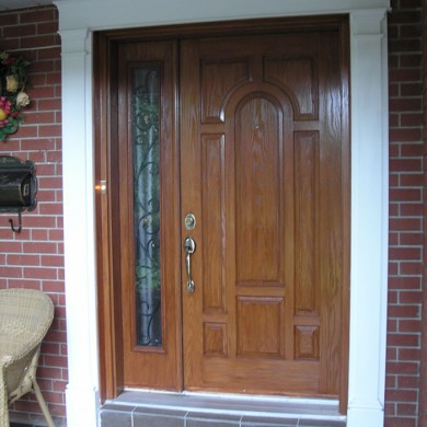 8 Panel Wood Grain Front Door with Side Lite Installed by Four Seasons Windows & Doors