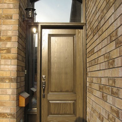 Wood Grain Front Door With Side Lite & Transom Installed by Four Seasons Windows & Doors