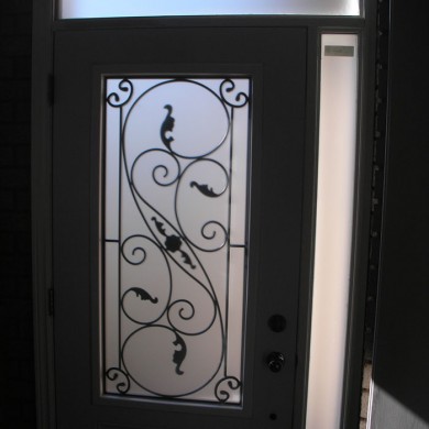Wrought Iron Door With Side lite & Transom Installed by Four Seasons Windows & Doors